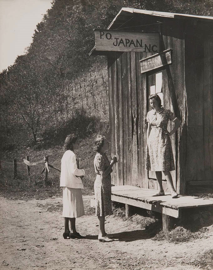 Three women gathered outside a small post office in Japan, North Carolina.