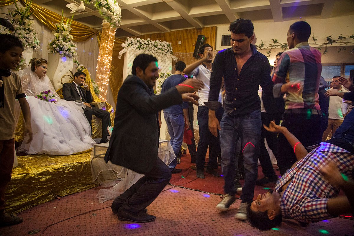 Hussein whispers to his wife Hind at their wedding, Baghdad, Iraq, 2012. From The Forgotten by Ali Arkady.
