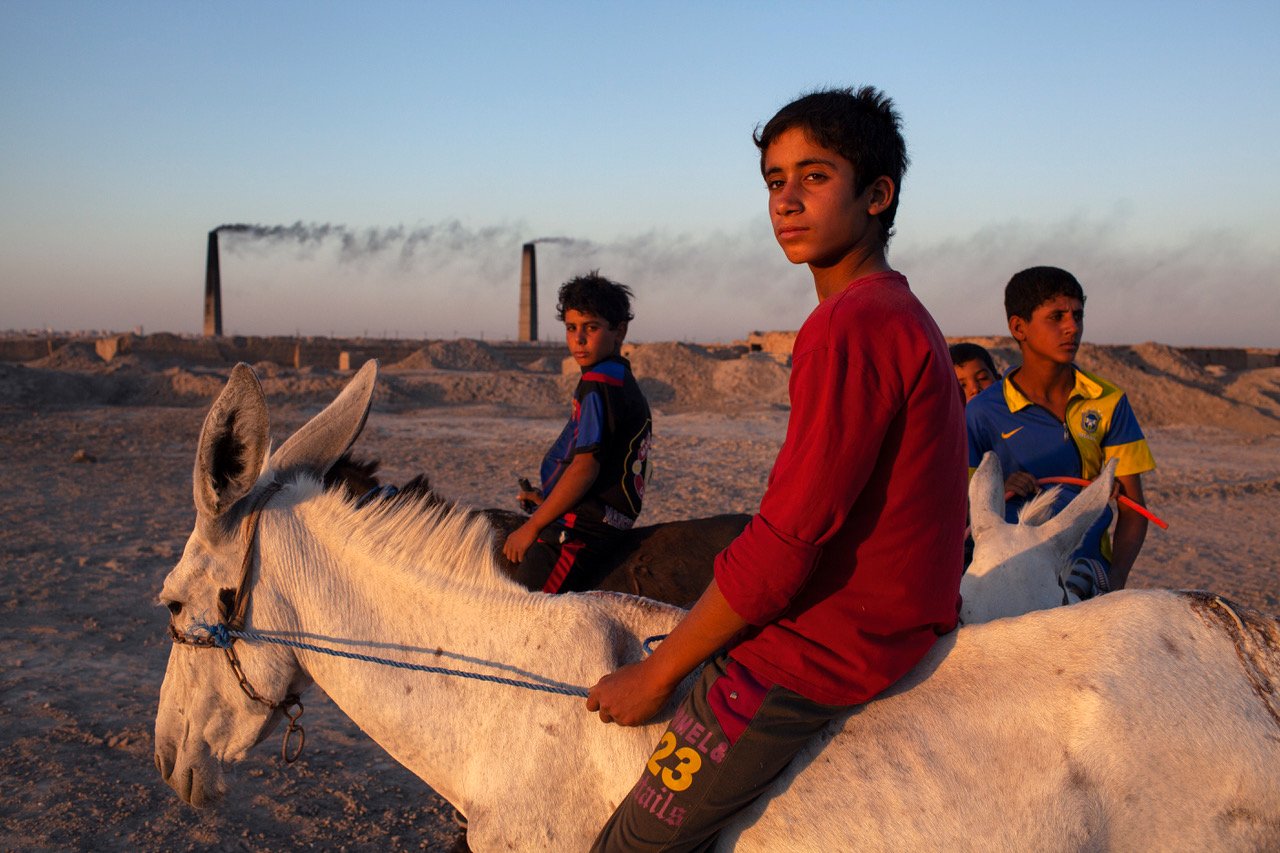Four children on a donkey near the brick factories, Najaf, Iraq, 2013. From Mountain of Gold by Ali Arkady.