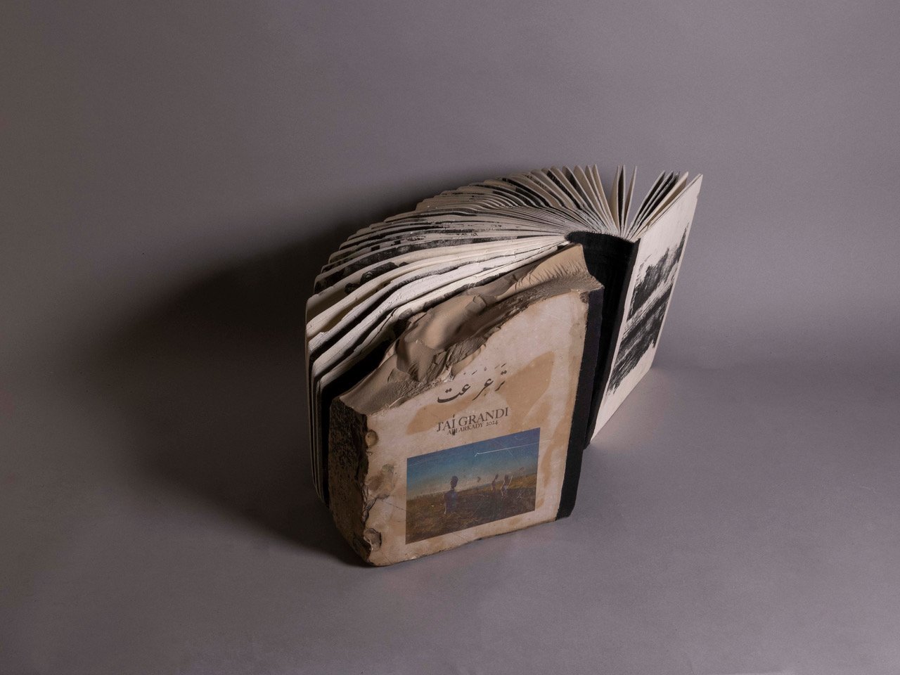 J'ai grandi — the stone book by Ali Arkady, showing the bound pages of stone and carton.