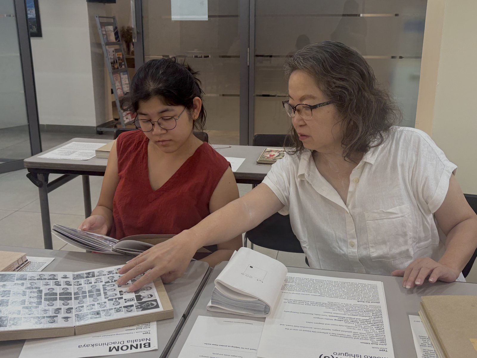 A mother and daughter browsing artist books at The Book Walks On.