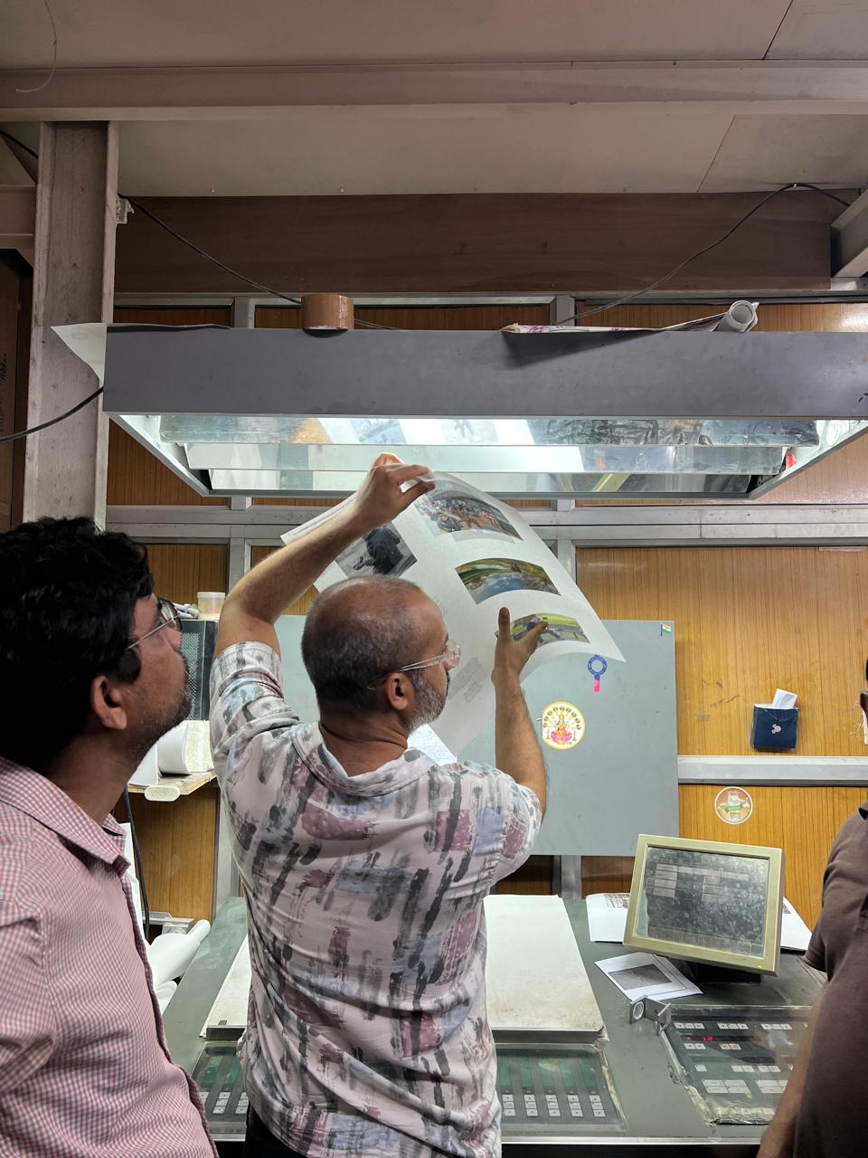 A printed spread from one of Ritesh Uttamchandani's books laid out on a white surface.