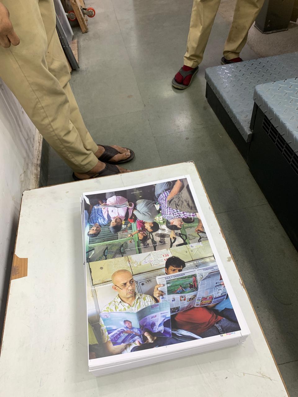 Stacked dummy book pages on a table in a print workshop.