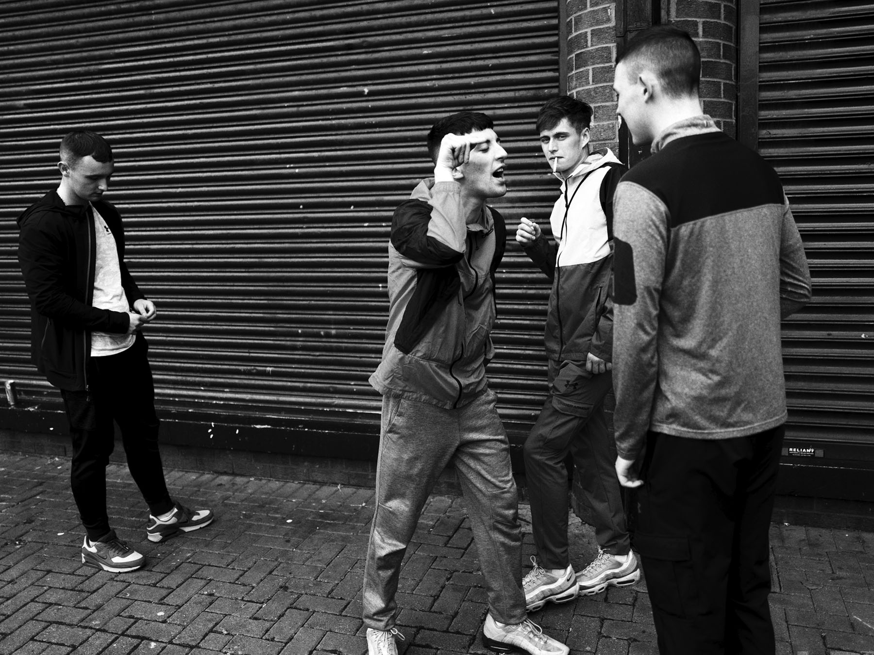 Michael and Sean arguing while David and Joe are smoking cigarettes, Belfast, July 2023.