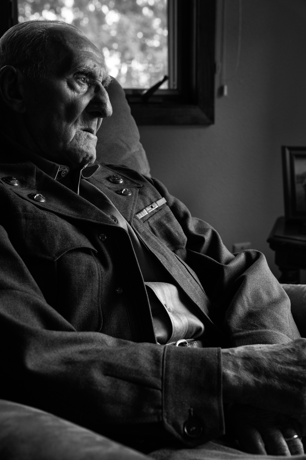 Korean War veteran in his original uniform, photographed at home